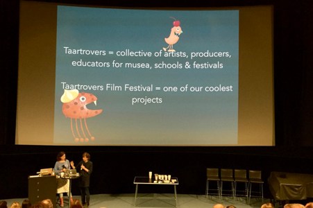 Two women at a stage, illustrations in the background and the name Taartrovers Film festival