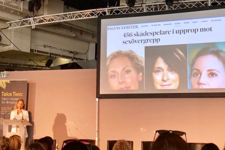 A woman talking on a stage 