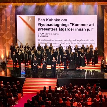 Lots of women in black on stage